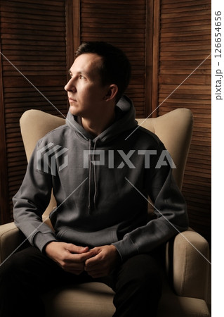 Contemplative Young Man Dressed in Casual Comfortable Attire, Appearing Calm and Chill 126654656