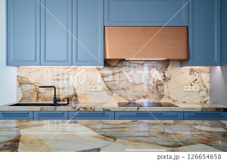 Elegant and Stylish Modern Kitchen Design featuring Luxurious Marble Accents throughout 126654658