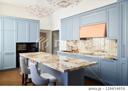 This is a Modern Light Blue Kitchen featuring an Elegant Marble Countertop, perfect for any home This is a Modern Light Blue Kitchen featuring an Elegant Marble Countertop, perfect for any home 126654659