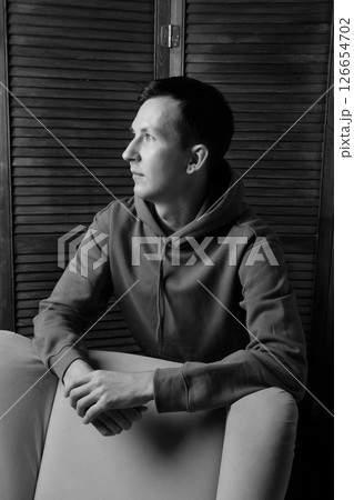 A Contemplative Portrait of a Young Man Captured in Striking Black and White Tones 126654702