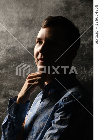 Contemplative Portrait Featuring Dramatic and Striking Lighting Effects for Artistic Appeal Contemplative Portrait Featuring Dramatic and Striking Lighting Effects for Artistic Appeal 126654858