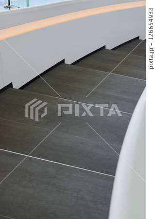 Explore the beauty of a Modern Curved Staircase Design enhanced with Elegant Lighting 126654938