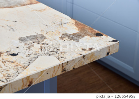 An Elegant Marble Tabletop featuring Unique and Beautiful Patterns in a Modern Kitchen Setting An Elegant Marble Tabletop featuring Unique and Beautiful Patterns in a Modern Kitchen Setting 126654958