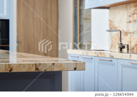 This is a modern kitchen that features an elegant countertop along with a stylish overall design This is a modern kitchen that features an elegant countertop along with a stylish overall design 126654994