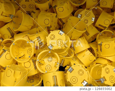 installation yellow electrical boxes use in construction projects across various sites. closeup. 126655002