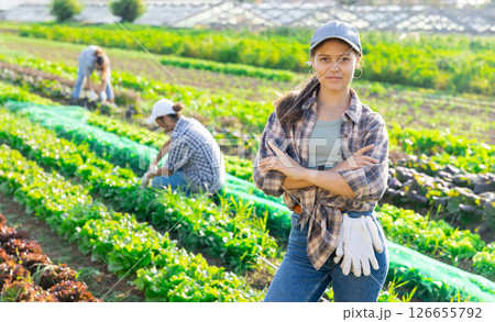 Young woman posing in field among harvest Young woman posing in field among harvest 126655792