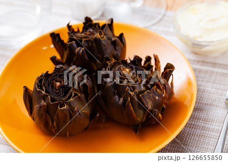 Delicious roasted artichokes served with garlic aioli sauce Delicious roasted artichokes served with garlic aioli sauce 126655850