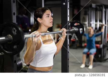 Athletic woman doing barbell exercises in gym 126656191
