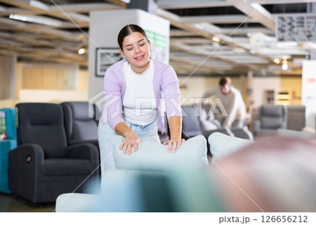 Young woman is looking for new furniture Young woman is looking for new furniture 126656212