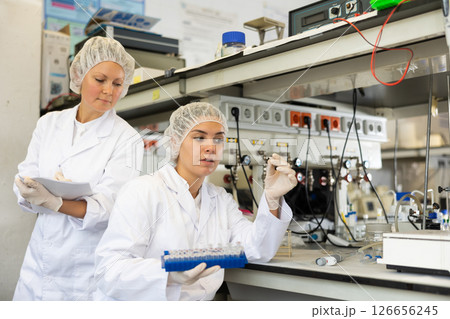 Confident women technicians working in research laboratory Confident women technicians working in research laboratory 126656245
