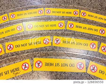 Do not sit here signage on the floor in a public space Do not sit here signage on the floor in a public space 126656550