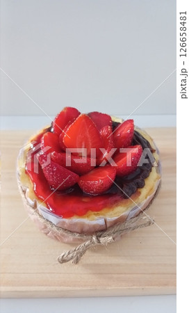 Rich and creamy burnt cheesecake with a perfectly caramelized top, crowned with fresh fruits for a delightful burst of flavor and texture in every bite. Rich and creamy burnt cheesecake with a perfectly caramelized top, crowned with fresh fruits for a delightful burst of flavor and texture in every bite. 126658481