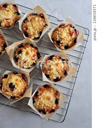 Moist and fluffy blueberry muffin bursting with juicy berries. A perfect balance of sweetness and tartness for a delightful anytime snack or breakfast treat. Moist and fluffy blueberry muffin bursting with juicy berries. A perfect balance of sweetness and tartness for a delightful anytime snack or breakfast treat. 126658571