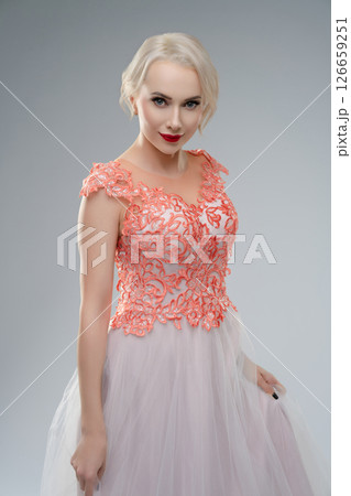 Eerie bride dressed in delicate gown poses dramatically in studio setting Eerie bride dressed in delicate gown poses dramatically in studio setting 126659251