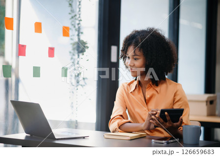 Asian woman feeling migraine head strain.Overworked businesswoman financier while working on laptop and tablet at office. Asian woman feeling migraine head strain.Overworked businesswoman financier while working on laptop and tablet at office. 126659683