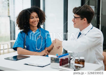 Doctor handshake and partnership in healthcare, medicine or trust for collaboration, unity or support.Team of medical experts shaking hands in teamwork for or success in clinic or hospital 126659933