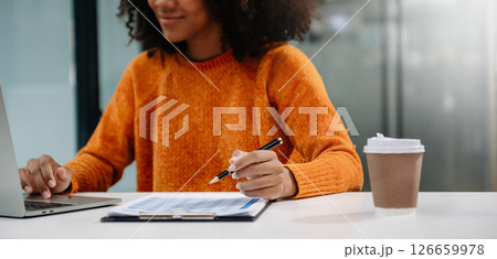Businesswoman hand using laptop, tablet and smartphone in office. Digital marketing media mobile app and discussing plan new start up project. Businesswoman hand using laptop, tablet and smartphone in office. Digital marketing media mobile app and discussing plan new start up project. 126659978