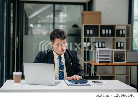 Young business man working at office with laptop, tablet and taking notes on the paper. 126660146