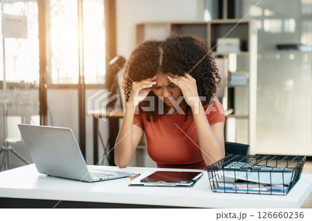 Business woman is stressed, bored, and overthinking from working on a tablet at office. Business woman is stressed, bored, and overthinking from working on a tablet at office. 126660236