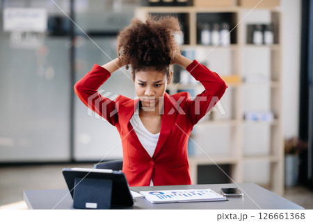 Asian business woman is stressed, bored, and overthinking from working on a tablet at the modern office. Asian business woman is stressed, bored, and overthinking from working on a tablet at the modern office. 126661368