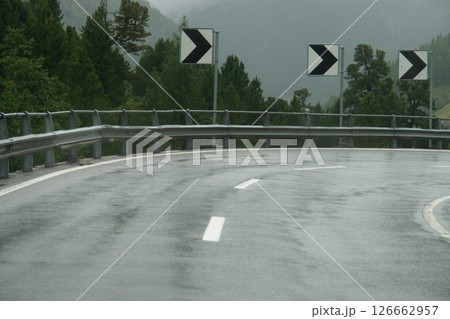 Road with a white line and a black arrow on it Road with a white line and a black arrow on it 126662957