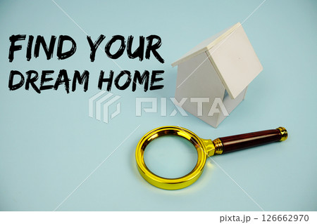 Find Your Dream Home text with White Model House and magnifying glass on blue background 126662970