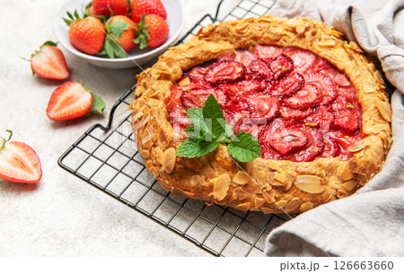 Delicious homemade strawberry galette cooling on wire rack Delicious homemade strawberry galette cooling on wire rack 126663660