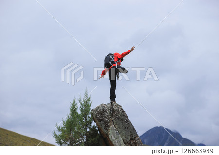 Hiking woman on high altitude mountain top 126663939