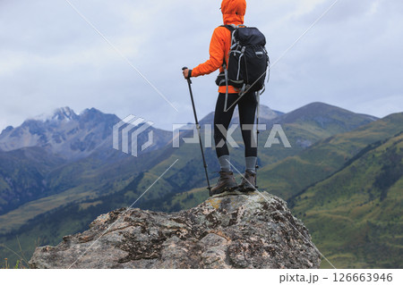 Woman backpacker hiking on high altitude mountain top 126663946