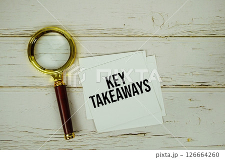 Key Takeaways text message on sticky note with magnifying glass on wooden background Key Takeaways text message on sticky note with magnifying glass on wooden background 126664260