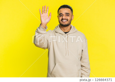 Happy man smiling friendly waving hands gesturing hello greeting or goodbye, meeting invitation 126664371