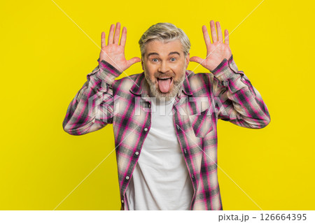 Mature man sticking out tongue, playful goofy expression, comedic silly face teasing humor vibe 126664395