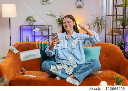 Money cash dollar rain falling on woman celebrating success, winning, good news lottery jackpot luck 126664406