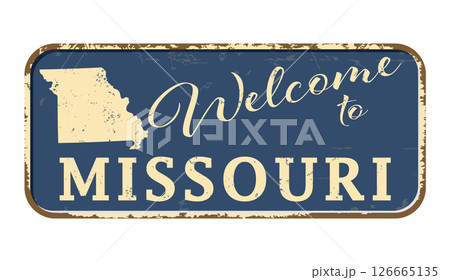 Welcome to Missouri. A worn blue plaque with the name and outline of the state. Welcome inscription on the road sign Welcome to Missouri. A worn blue plaque with the name and outline of the state. Welcome inscription on the road sign 126665135