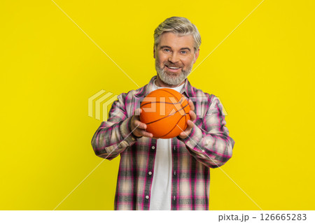 Mature man spinning basketball, playful dribble exchange, sporty game skill display energetic vibe Mature man spinning basketball, playful dribble exchange, sporty game skill display energetic vibe 126665283