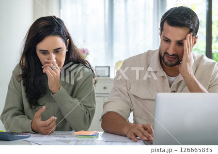 Couple overwhelmed by overdue bills and low income, facing economic stress and inflation-related financial crisis 126665835