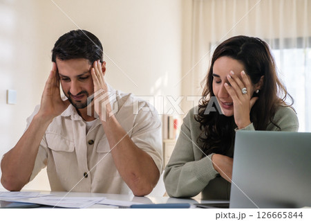 Couple overwhelmed by overdue bills and low income, facing economic stress and inflation-related financial crisis 126665844