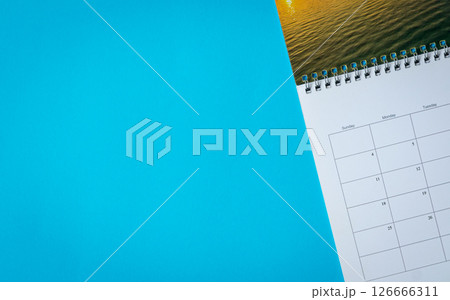 Calendar page on blue surface background. 126666311