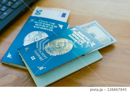 Two passports of the Republic of Kazakhstan and banknotes in denominations of euro and dollar. High quality photo 126667845