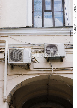 Air conditioning on facade of building and windows in the southern hot country. 126669073
