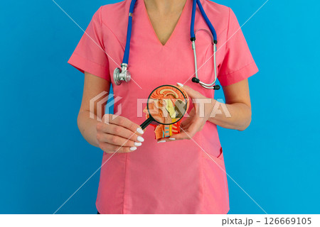 Female doctor with magnifying glass anatomical model human brain. Concept of early diagnosis of brain diseases Female doctor with magnifying glass anatomical model human brain. Concept of early diagnosis of brain diseases 126669105