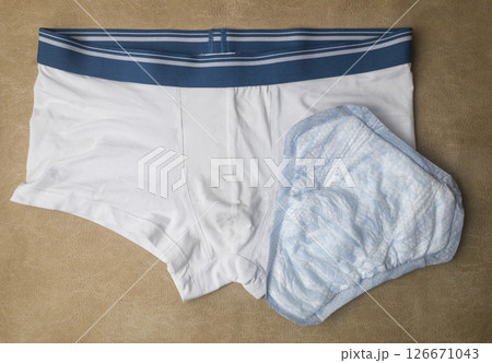 Male incontinence pads on white panties. Incontinence pads for men. Urinary incontinence. Sanitary pads for men with problems of the genitourinary system. Male incontinence pads on white panties. Incontinence pads for men. Urinary incontinence. Sanitary pads for men with problems of the genitourinary system. 126671043