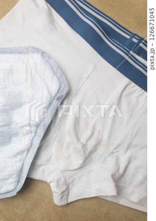 Male incontinence pads on white panties. Incontinence pads for men. Urinary incontinence. Sanitary pads for men with problems of the genitourinary system. Male incontinence pads on white panties. Incontinence pads for men. Urinary incontinence. Sanitary pads for men with problems of the genitourinary system. 126671045