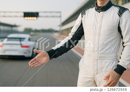 Race Car Driver Gesturing To Enter With Racetrack 126672939