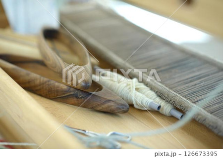 Handweaving Tools and Wool Yarn on Artisan Loom 126673395