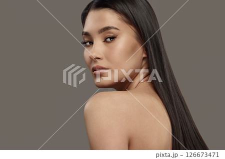 Luxurious young woman with naked back, long dark hair. 126673471