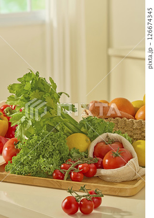 A fresh vegetable platter of kale, celery, tomatoes, and lemons and bell peppers is arranged on a yellow table, drawing attention with its colorful array of healthy produce A fresh vegetable platter of kale, celery, tomatoes, and lemons and bell peppers is arranged on a yellow table, drawing attention with its colorful array of healthy produce 126674345