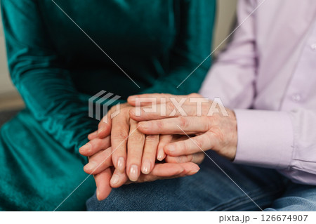 Old couple hands. Senior couple in love holding hands. Mid age old husband wife touching hands with tenderness love enjoying wellbeing. Grandmother grandfather together. Family moment love and care Old couple hands. Senior couple in love holding hands. Mid age old husband wife touching hands with tenderness love enjoying wellbeing. Grandmother grandfather together. Family moment love and care 126674907