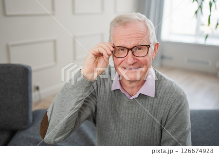 Portrait of confident stylish European middle aged senior man at home. Older mature 70s man smiling. Happy attractive senior grandfather looking camera close up face headshot portrait. Happy people 126674928