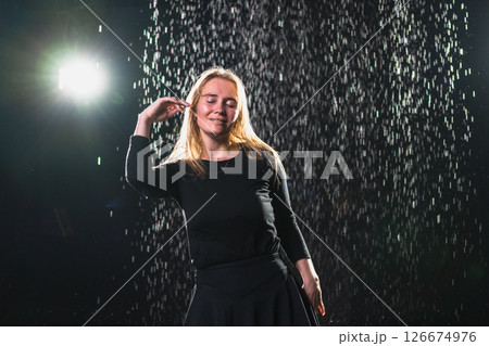 Contemporary woman dancer posing in rain water on black background. Female artist performer dancing with expression. Modern ballerina dancing in darkness. Passion dance in dark. Flexibility balance Contemporary woman dancer posing in rain water on black background. Female artist performer dancing with expression. Modern ballerina dancing in darkness. Passion dance in dark. Flexibility balance 126674976
